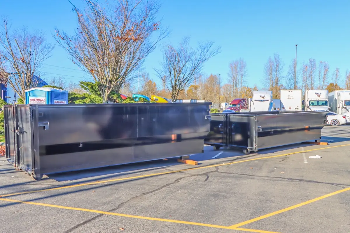 Professional dumpster rental service with roll-off container on residential driveway in Forest Glen